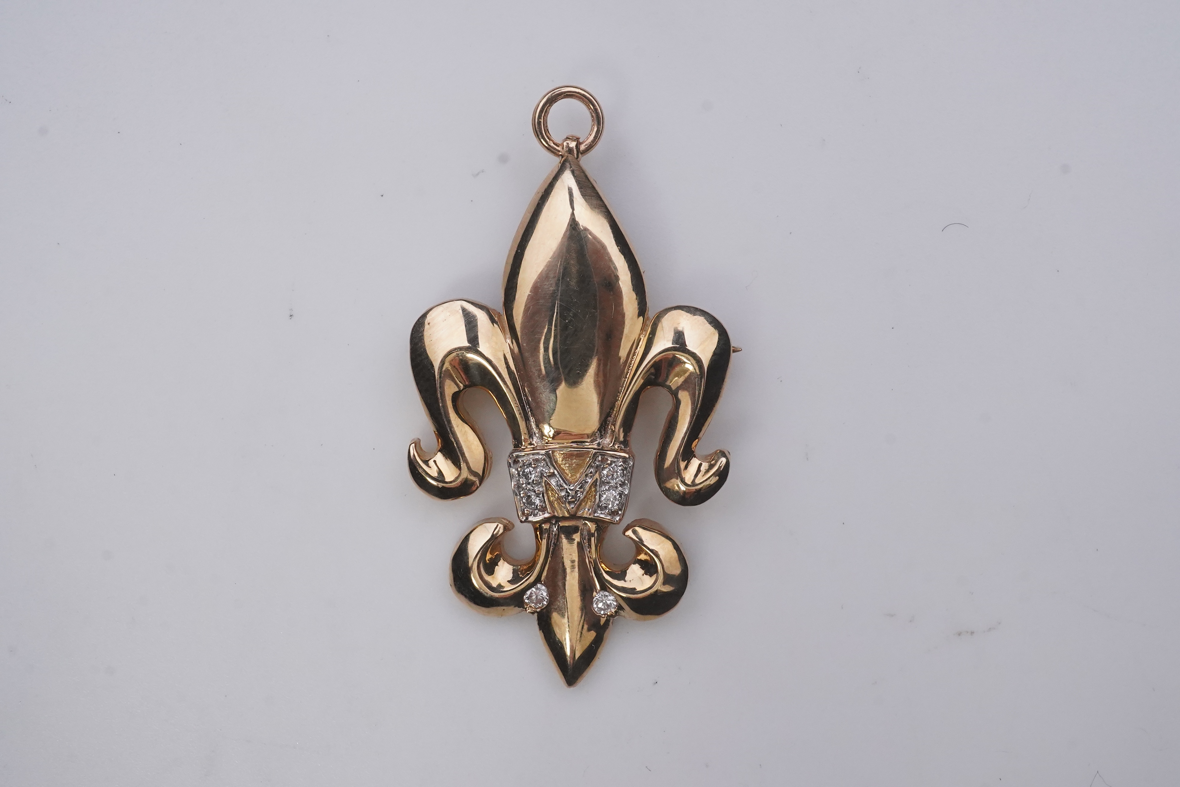 A gold and diamond pendant/brooch